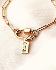 Personalize the Tag with an Initial or symbol. It makes a fantastic, thoughtful gift for the ladies in your life. Item Details: • This listing is for (1) Paperclip Charm Bracelet with a Tag.• This Paperclip Charm Bracelet comprises a 14K Gold Filled chain, a 14K Gold Filled tag, and a Sterling Silver carabiner clasp plated in Yellow Gold. Collect your favorite charms to connect to the Carabiner Clasp, and wear a different pendant daily. • Avoid contact with anything containing derivatives of alc 1st Wedding Anniversary Gift Ideas, 1st Year Wedding Anniversary, Her Birthday Gift Ideas, Bracelet Tag, Wedding Anniversary Gift Ideas, Anniversary Gift Ideas For Him, 1st Wedding Anniversary Gift, Paperclip Bracelet, Classy Necklace