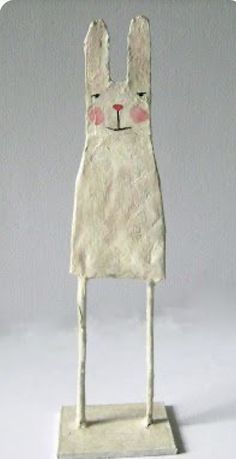 a paper mache of a rabbit on a white background