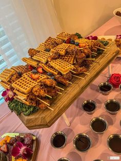 a table topped with waffles and other foods