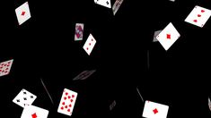 several playing cards are flying in the air with red and white dices on them