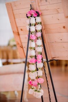 flowers are hanging from the back of a wooden structure