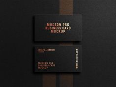 two black business cards with gold foil on them