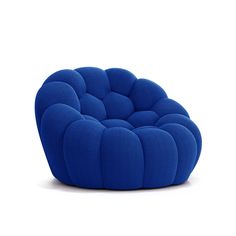 a blue chair that is sitting in the middle of a white flooring area with a circular cushion on it's back end