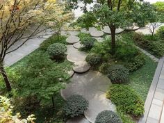 an aerial view of a garden with trees and benches