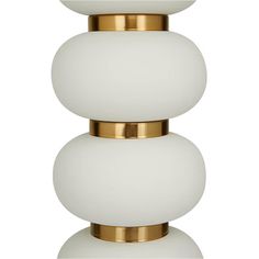 a white and gold table lamp with three balls on the top, one light is turned off