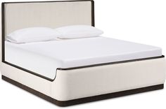 a bed with white sheets and pillows on top of it's headboard, in front of a white background