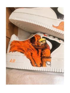 a pair of shoes with an orange fox painted on them