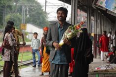 two men walking down the street in front of a group of people with cameras on their laps