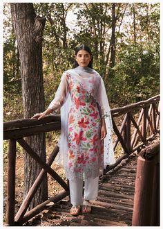 Presenting an elegant three-piece kurti set, meticulously fashioned from a luxurious premium fabric in a grey hue. The kurti, adorned with intricate floral patterns scattered across its expanse, exudes understated sophistication. Elbow netted sleeves are an add-on. Paired with matching plain straight pants, this ensemble ensures both comfort and style, effortlessly accompanying you throughout the day. Complementing the attire is a soft net dupatta, harmonizing seamlessly with the color and patte Spring Multicolor Kurta With Sheer Dupatta, Silk Salwar Kameez With Floral Print For Summer, Summer Silk Salwar Kameez With Floral Print, Silk Salwar Kameez With Floral Print For Summer Festivals, Elegant Floral Print Kurta For Festive Season, Floral Print Spring Kurta For Wedding, Summer Floral Print Silk Salwar Kameez, Elegant Floral Print Palazzo Set For Festive Season, Spring Wedding Kurta With Floral Print