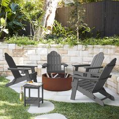 three adiron chairs sitting around an outdoor fire pit