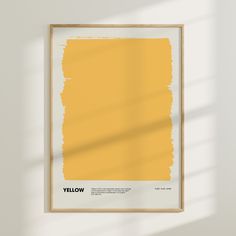 a yellow poster hangs on the wall in an empty room with sunlight streaming through it