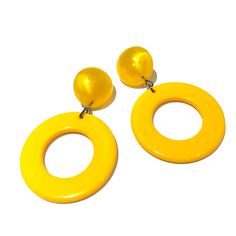 Sunshine or bright yellow Go-Go hoop drops from vintage aura glow lucite studs. Geometric lucite earrings made with vintage parts. These are big & make a statement. Mod meets 80's opulence. Measures just under 2.25" or 60mm from top to bottom, but super lightweight with just enough swing to make a statement. Earrings are made with vintage lucite parts that were made in Rhode Island in the 1960's - early 80's by Best Plastics. We hand-set them with surgical steel earring posts and they have sturd Yellow Plastic Party Jewelry, Yellow Retro Party Earrings, Retro Yellow Party Earrings, Retro Yellow Earrings For Party, Trendy Yellow Plastic Earrings, Vintage Yellow Resin Jewelry, Retro Hoop Earrings For Parties, Yellow Round Hoop Earrings For Party, Bold Yellow Drop Earrings