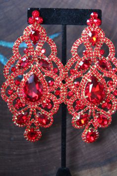 "These fun and stylish extra wide crystal rhinestone earrings are a great statement piece! Size of earrings: 2.25\" Wide and 4.5\" Long. Color: red Base metal: gold Style: pierced and clip on available! More colors available upon request, just message us! Looking for a matching bracelet? https://www.etsy.com/listing/538148439/red-crystal-bracelet-large-crystal?ref=shop_home_active_33 Looking for the perfect pair of earrings for a special occasion. We specialize in custom work in fashion jewelry, Red Pageant Earrings, Traditional Luxury Red Chandelier Earrings, Red Prom Earrings, Red Bling Jewelry For Evening, Red Glamorous Chandelier Earrings For Evening, Glamorous Red Chandelier Earrings For Evening, Red Glamorous Chandelier Earrings For Party, Glamorous Red Crystal Earrings For Party, Glamorous Red Chandelier Earrings For Party