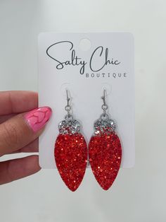 a pair of red glitter heart shaped earrings