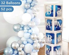 baby shower balloons are arranged on the floor in front of a white and blue balloon arch