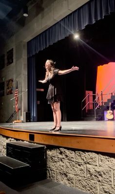 a woman standing on top of a stage