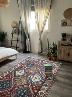 a bed room with a neatly made bed and a rug on the floor next to it