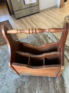 an old wooden caddy on the floor in a kitchen