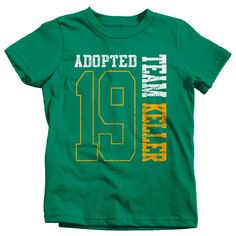 "Kids Personalized Adopted T Shirt Matching Custom Matching Family Shirts Adoption Adopting Tee Athletic Team TShirt Toddler Let everyone know that you're officially become a family in this personalized adoption t shirt. This tee will be personalized with your family name and year. Please leave the name, year, and print color preference in the notes section at checkout. The design is big, bold and athletic styled. It will feature the last two digits of the year the adoption happened as well as t Green Team Spirit Short Sleeve T-shirt, Green Short Sleeve Team Spirit T-shirt, Green Short Sleeve T-shirt With Team Spirit Style, Green Crew Neck Top With Team Spirit Style, Green Crew Neck Top For Team Spirit, Green Short Sleeve Top For Team Spirit, Green Short Sleeve Tops With Name Print, Green Short Sleeve Top With Name Print, Green Graphic Tee With Team Name