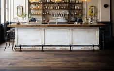 an old fashioned bar with lots of bottles on it