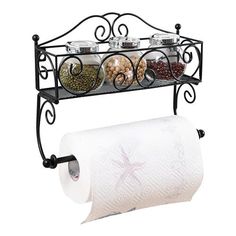 an iron shelf with two rolls of toilet paper and spices on it next to a roll of tissue