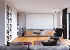 an empty living room with a large screen