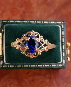 A Gorgeous Solid 14ct Gold Lab Sapphire Cluster Ring, Fully Hallmarked. Vintage from the 1980s Materials: 14ct Gold Gemstone: Lab Sapphire The Sapphire measures 5x7 mm Total Weight: 1.6g Size UK: P Size US: 7 1/2 Condition: Excellent The Ring comes with a set of Full British Hallmarks for authenticity. The pretty ring will arrive beautifully gift wrapped. Please note I'm shipping from the UK. I will post your order in 1-3 working days after confirmed payment, if you need something fast let me kn Vintage 14k Gold Sapphire Birthstone Ring, Vintage Gold Sapphire Ring Gift, Classic 14k Gold Sapphire Collectible Ring, Collectible Classic 14k Gold Sapphire Ring, Classic Hallmarked Sapphire Ring As Gift, Vintage 14k Gold Sapphire Ring, Vintage Yellow Gold Sapphire Ring For Gift, Heirloom Sapphire Ring Stamped 14k For Gift, Heirloom Sapphire Ring Stamped 14k As Gift