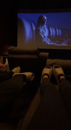 two people watching a movie in the dark