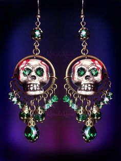 "These Dangly Crystal Gothic Skull Chandelier Earrings are made with sparkling crystal beads and hand-painted skulls with rhinestone eyes. The painted dripping blood and antiquing makes this pair super scary! Love these for an everyday Gothic or Dark style. They're fun to wear and make a statement. Available with Posts, Clip-Ons or French Wires. -3 1/2\" Long x 1\" Wide -0.4 oz. ea. Metal Finishes Available: -Bronze -Silver Colors Available: -Black Cat -Witchy Purple -Spooky Green -Blood Red *Co Bohemian Halloween Party Jewelry, Bohemian Jewelry For Halloween Party, Halloween Skull-shaped Jewelry For Jewelry Making, Halloween Skull Jewelry For Jewelry Making, Halloween Jewelry Making Skull Beads, Halloween Skull-shaped Jewelry Making Supplies, Nickel-free Skull Jewelry For Party, Green Halloween Dangle Earrings, Mystical Dangle Jewelry For Halloween