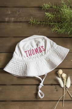 Get your little one ready for their first summer adventures! A super cute and adjustable gender neutral summer hat for baby or toddler, personalized with their first name! Bucket hats are available in your choice of white or cargo and baby name is custom embroidered using a sturdy, high-quality thread. The personalized detail of the hat makes it extra special! Perfect for a day at the beach, shore or camping and these customized bucket hats make a stand-out baby gift! Buyer customizations are: Playful Adjustable Sun Hat With Upf 50+, Playful Sun Hat With Upf 50+ And Adjustable Fit, Playful Adjustable Bucket Hat With Upf 50+, Cute Adjustable Sun Hat For Summer, Adjustable Summer Bucket Hat For Playtime, Cute Summer Hat With Adjustable Fit, Adjustable White Bucket Hat For Vacation, Adjustable Fit White Bucket Hat For Vacation, Cute Adjustable Summer Hat