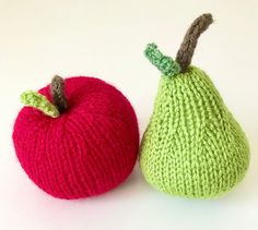 two knitted fruit sitting next to each other