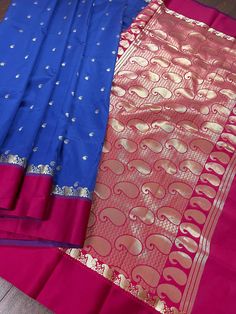 Gorgeous Statement designer Saree by Kaash Collection. Blue with small Buttis all over the body of the Saree. Plain Magenta Pink Color Borders and Zari Weaved Pallu in ambi Style. Item : SareeColor : Blue with Magenta Pink Border Base Fabric : Soft Banarasi Silk Blouse piece : Comes with Blouse pieceBlouse material : Soft Banarasi Silk Work : Handloom Fall & Edging(Yes/No) : Yes Disclaimer -:- Color variation is possible due to various reasons like phone or desktop setting, resolution etc. Pleas Blue Wedding Saree With Border, Blue Bollywood Dupatta With Border, Blue Anarkali In Katan Silk, Festive Blue Dupatta With Border, Blue Dupatta With Border For Diwali, Blue Anarkali Traditional Wear In Katan Silk, Blue Anarkali Katan Silk Traditional Wear, Bollywood Style Blue Traditional Wear With Border, Festive Royal Blue Saree With Traditional Patterns