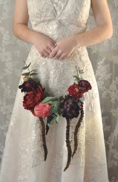 a woman in a wedding dress holding flowers