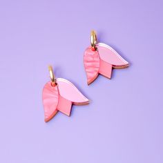 These Tulip charms add a lovely monochrome pop of color and are small and cute enough for when you want to be a little subtle. Hand-crafted from a combo of marbled, mirrored and frosted acrylic, paired with hand-stained wood. They hang from elegant 15mm gold-filled hoops and are removable so you can wear the hoops on their own—two earrings in one, perfect for travel! Hand-crafted in New York City. Gold-filled hoops are perfect for sensitive ears! Due to the hand-made nature of these pieces, your Vynil Earrings, Diy Resin Earrings, Tulip Earrings, Two Earrings, Red Charm, Hoop Charms, Frosted Acrylic, Purple Tulips, Gold Filled Hoops