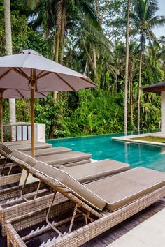 lounge chairs and umbrellas are by the pool