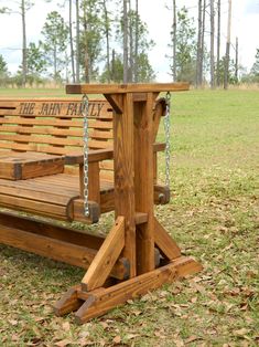 a wooden bench with chains hanging from it's sides and the name, the ann family