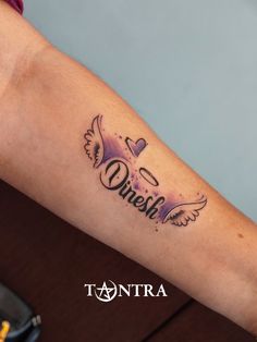 a woman's arm with a tattoo that reads, queen and an angel on it