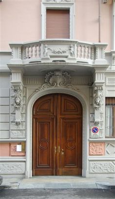 an old building with two large wooden doors