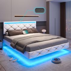 a bed that has some lights on the headboard and foot board in front of it