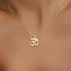 14K Gold Plated Om Necklace, Gift for Her, Spiritual Gift, Yoga Necklace, Christmas Gifts, Dainty Necklace, Symbol Necklace, Gift for Mom - OM NECKLACE - We create dainty, unique, and personalized jewelry perfect for any occasion, from Christmas gifts and birthdays to Mother's Day, anniversaries, and bridesmaid gifts. Explore our collection to find the ideal piece for celebrating life's special moments. OTHER FEATURES * High-Quality Materials: Crafted from 925 Silver, not stainless steel. * Color Options: Offered in Gold, Rose Gold, and White Gold. * Eco-Friendly and Hypoallergenic: Nickel-free, tarnish-resistant, and made with eco-friendly materials. * Packaging: Comes in a lovely jewelry box, perfect for gifting. * Customer Support: We're here to assist with any product issues or inquiri Gold Spiritual Necklace For Gifts, Spiritual Gold Necklace Gift, Spiritual Cadmium-free Charm Necklace As Gift, Spiritual Jewelry For Christmas Gift, Hindu Jewelry, Om Necklace, Om Pendant, Yoga Necklace, Symbol Necklace