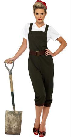 a woman wearing overalls and holding a shovel