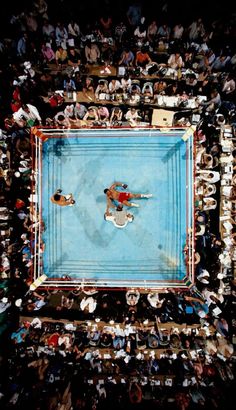 an overhead view of a tennis match with spectators