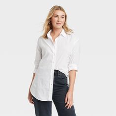 Warm-weather work days or weekend coffee dates, this Tunic Long-Sleeve Collared Button-Down Shirt from Universal Thread™ has you covered in refined style. The woven voile shirt is made of lightweight cotton with a collared neckline, full button placket and shirttail hem to elevate your comfort and style game. Designed in a solid color, the long-sleeve shirt has buttoned cuffs, a back yoke and a tunic-length silhouette for creating versatile tucked-in or untucked ensembles with a variety of botto Garment Details, White Button Down Shirt, Over 50 Womens Fashion, Style Basic, White Button Down, Hem Style, Tunic Length, Universal Thread, Womens Tunics