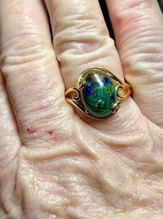 Gemstone: genuine natural oval cabochon cut azurmalachite Size: 14mm x 10mm x 7mm Weight: 8.58cts approximately  Metal: .925 stamped Sterling Silver, 18kt yellow gold plated Size: 10 Weight: 5.3g Gold Oval Hallmarked Turquoise Ring, Oval Cabochon Emerald Ring For May Birthstone, Elegant Green Opal Ring Oval Cabochon, Elegant Green Opal Ring With Oval Cabochon, Oval Cabochon Rings For May Birthstone, Green Oval Opal Ring With Polished Finish, Green Oval Opal Ring, Malachite Gemstone Jewelry For Formal Occasions, Formal Malachite Gemstone Jewelry