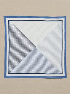 a blue and white square with diagonals on the bottom, in front of a beige background