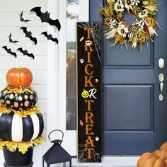 a front porch decorated for halloween with pumpkins and decorations