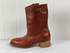 "Vintage 1980s (?) brown leather Engineer motorcycle boots. Soft toe. Has buckle at the calf. Made in U.S.A. by Carolina. Size 8. The soles measure 11 5/8\" long from against the wall  (about 10 3/8\" inside) 4 1/8\" wide  Boots are 11 1/2\" tall. In very good condition." Vintage Work Boots With Goodyear Welt Construction For Fall, Vintage Boots With Goodyear Welt Construction For Winter, Vintage Winter Boots With Goodyear Welt Construction, Vintage Ankle Moto Boots With Buckle Closure, Vintage Ankle Boots With Buckle Closure, Vintage Brown Moto Boots With Goodyear Welt, Vintage Brown Moto Boots With Goodyear Welt Construction, Brown Vintage Moto Boots With Goodyear Welt, Vintage Moc Toe Moto Boots For Fall