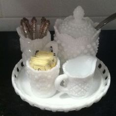 a white tray topped with cups and saucers