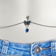 a pair of jeans with a chain attached to it and a heart charm hanging from the back