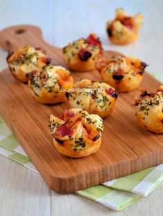 small muffins with bacon and cheese on a cutting board